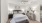 a bedroom with a bed and a fan