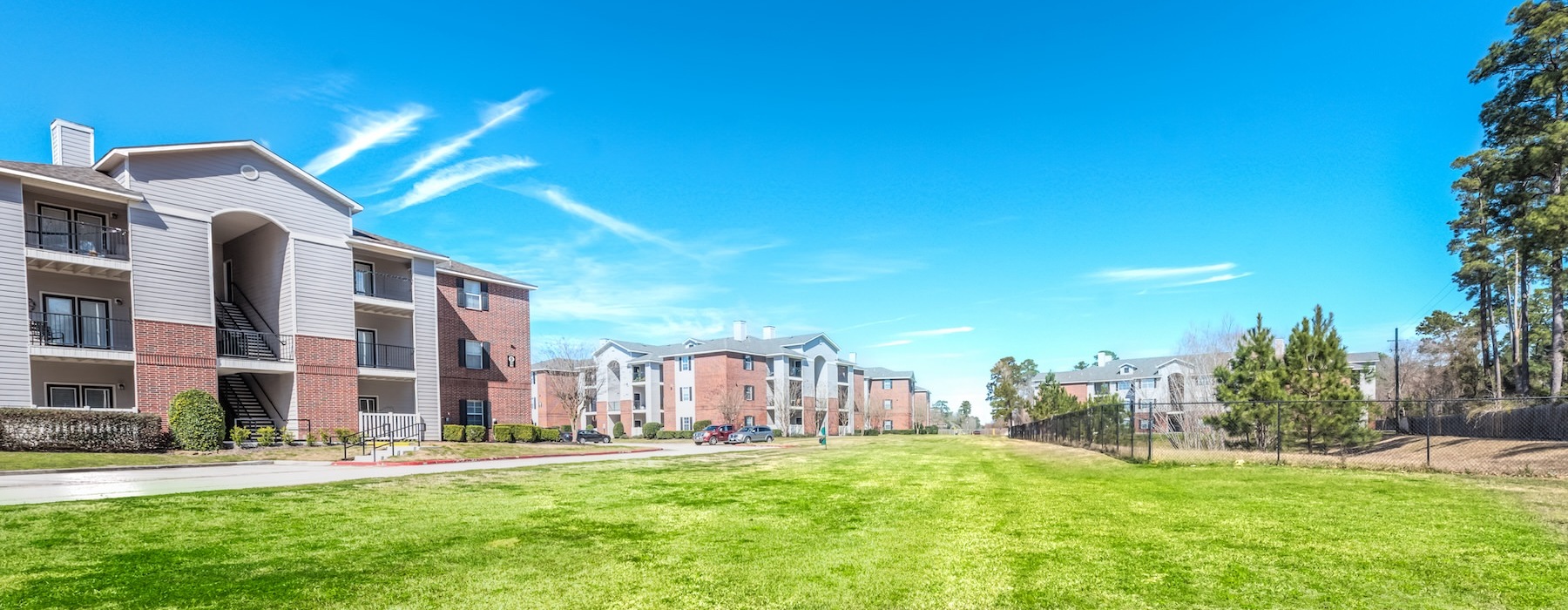a large building with a lawn in front of it