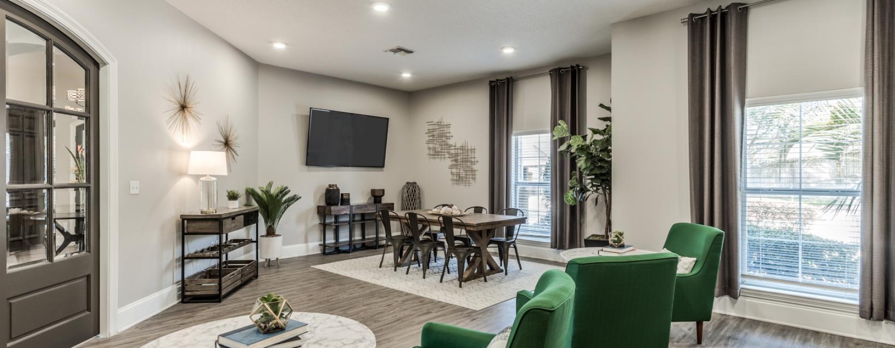 a clubhouse room with green chairs