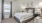 a bedroom with a bed and a fan